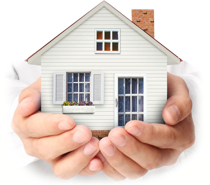 A model of a house held in a pair of hands.